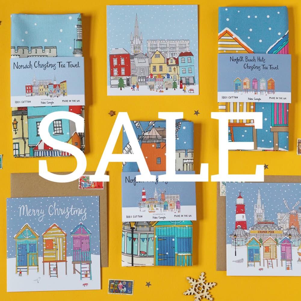 A photo of a collection of various Christmas themed products, including Tea Towels and Christmas Cards