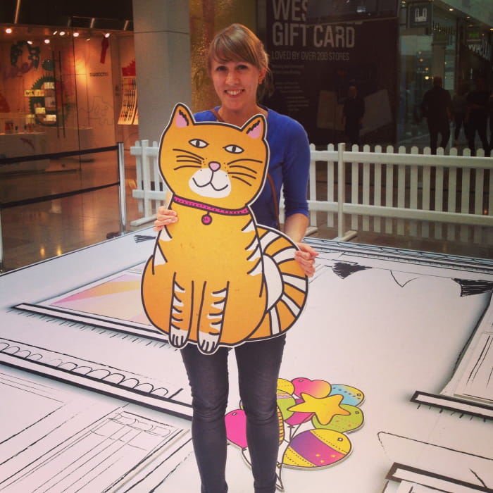 Helena holding cat prop created from an illustration